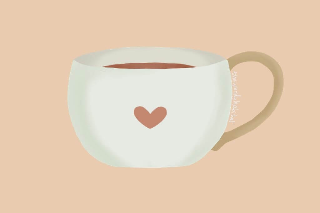 mug filled with tea. a small heart is printed on the mug.
