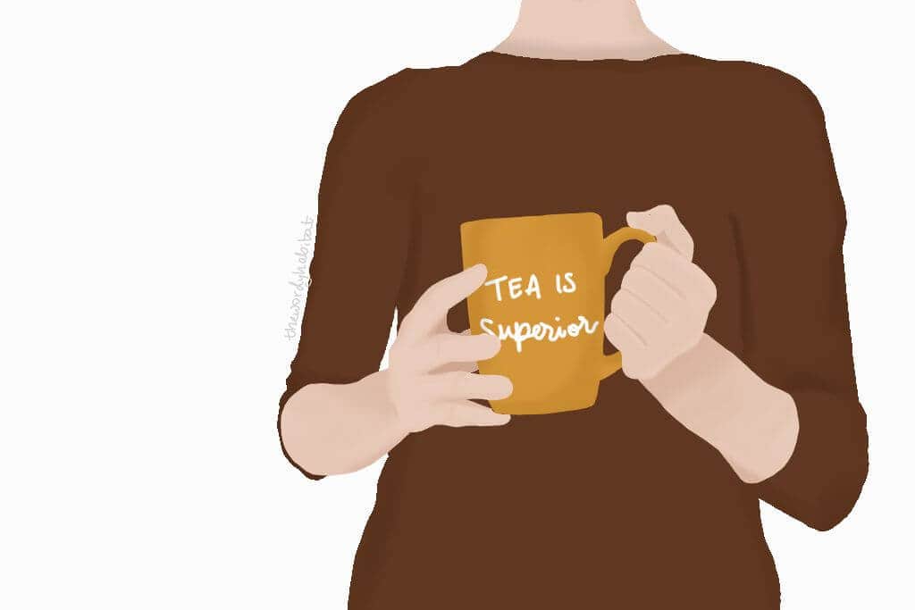 person holding mug that says "tea is superior"