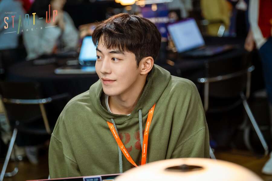 Nam Do-san smiling at someone, wearing a green hoodie