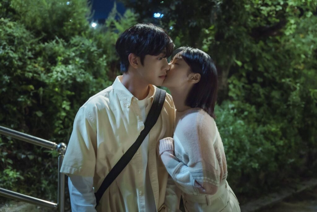 still from a time called you kdrama showing han jun hee kissing nam si heon on the cheek