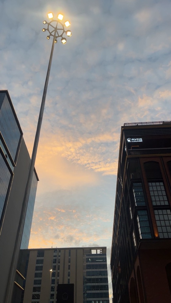 a snap of the evening sky peppered with orange-tinted clouds in a blue backdrop