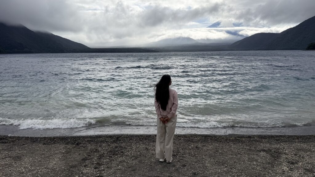 me on the lakeshore of lake motosu, with the base of Mt. Fuji visible